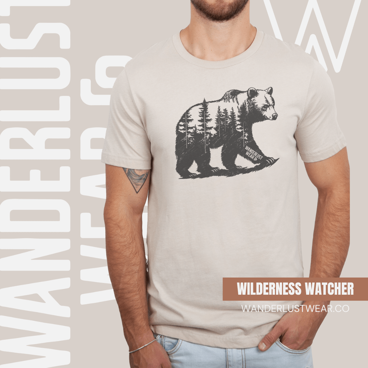 Model wearing Roam Wild Bear graphic tee in Heather Grey, featuring hand-drawn bear silhouette with pine trees and Wanderlust Wear Co. branding