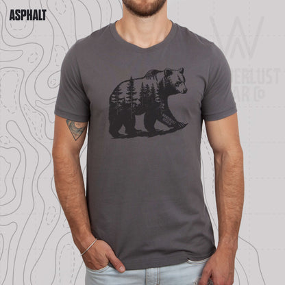 Model wearing Roam Wild Bear graphic tee in Asphalt, featuring hand-drawn bear silhouette with pine trees and Wanderlust Wear Co. branding