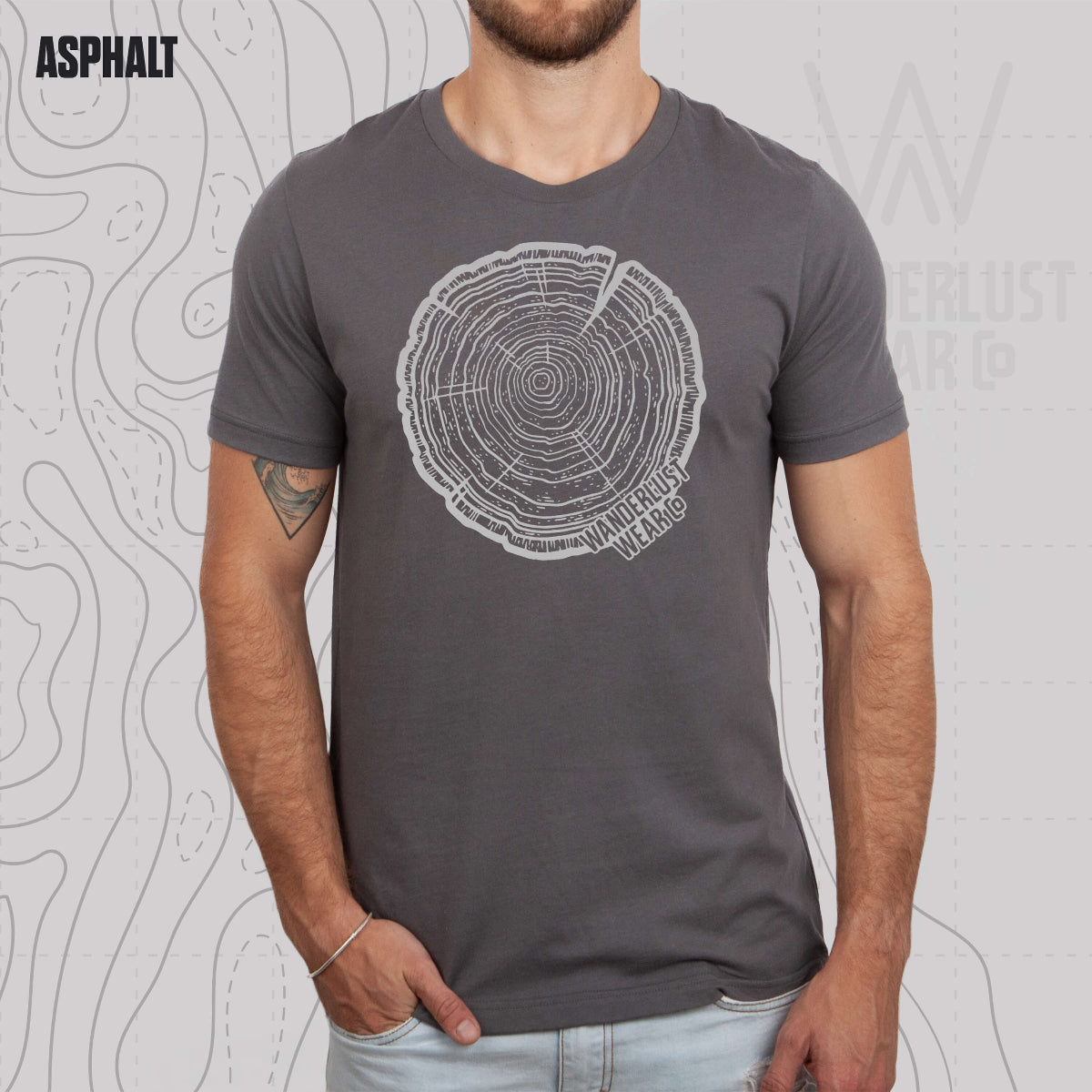 Model wearing Tree Rings Heritage graphic tee in Asphalt, featuring hand-drawn tree trunk cross-section design by Wanderlust Wear Co.