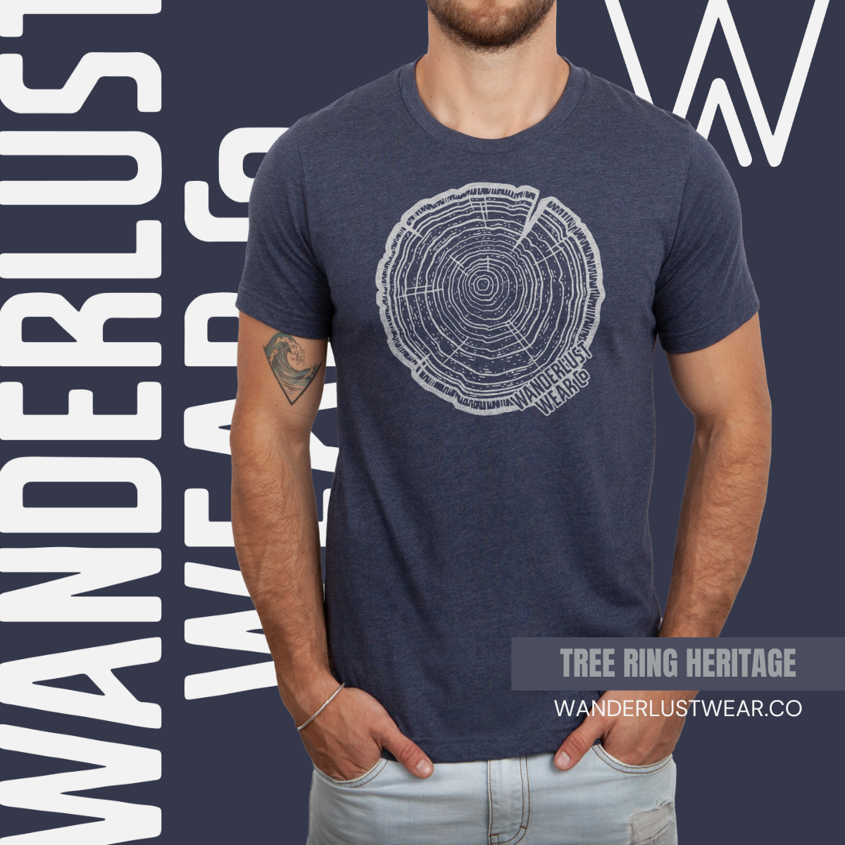 Model wearing Tree Rings Heritage graphic tee in Heather Navy, with hand-drawn tree ring design and Wanderlust Wear Co. branding in the background