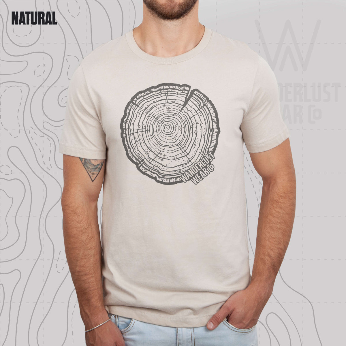 Model wearing Tree Rings Heritage graphic tee in Natural, featuring hand-drawn tree trunk cross-section design by Wanderlust Wear Co.