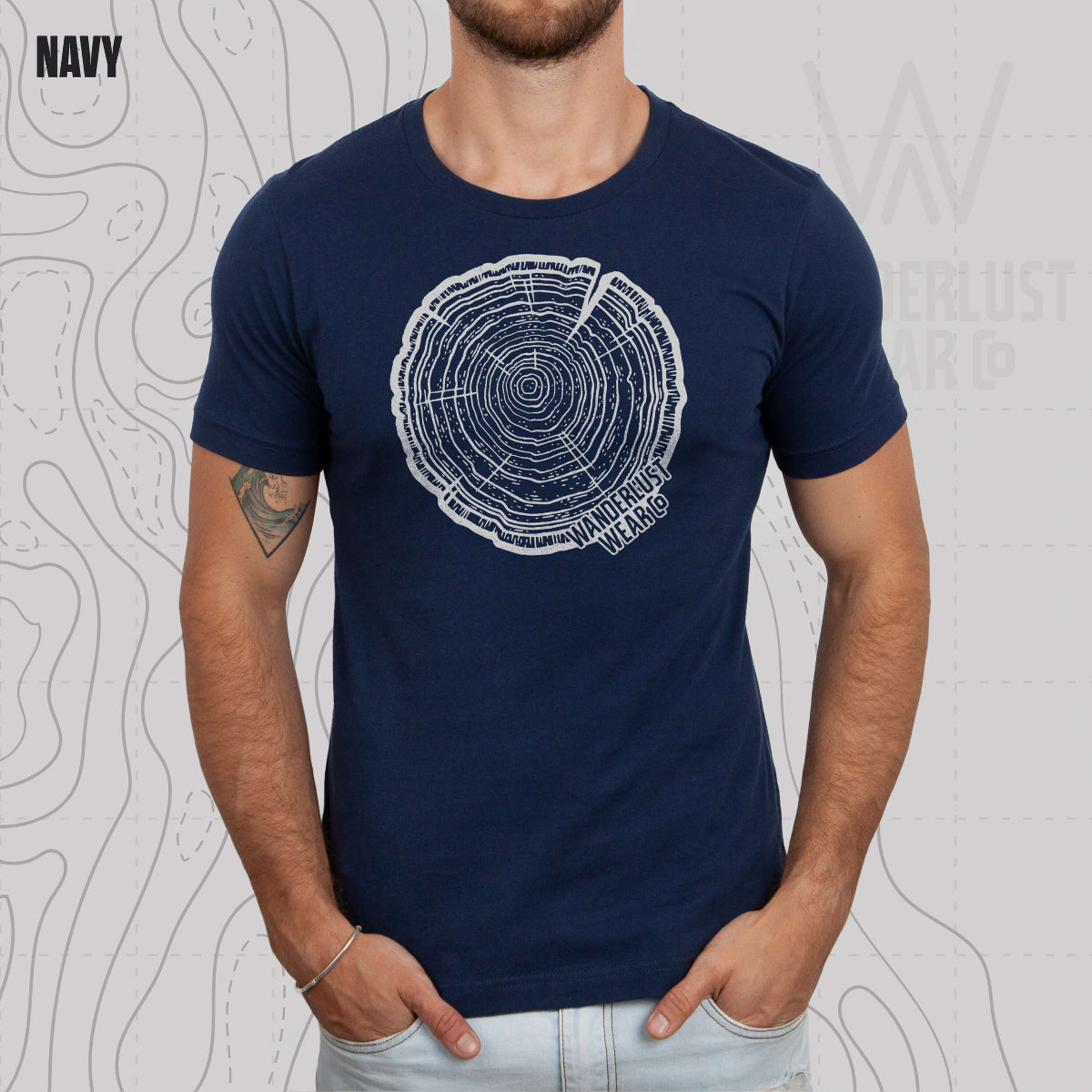 Model wearing Tree Rings Heritage graphic tee in Navy, featuring hand-drawn tree trunk cross-section design by Wanderlust Wear Co.