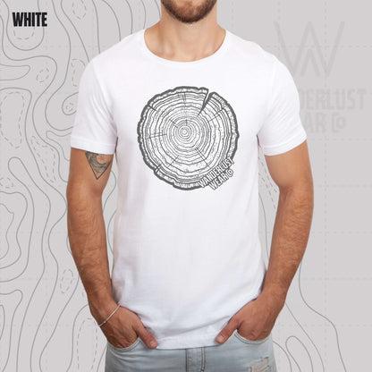 Model wearing Tree Rings Heritage graphic tee in White, featuring hand-drawn tree trunk cross-section design by Wanderlust Wear Co.