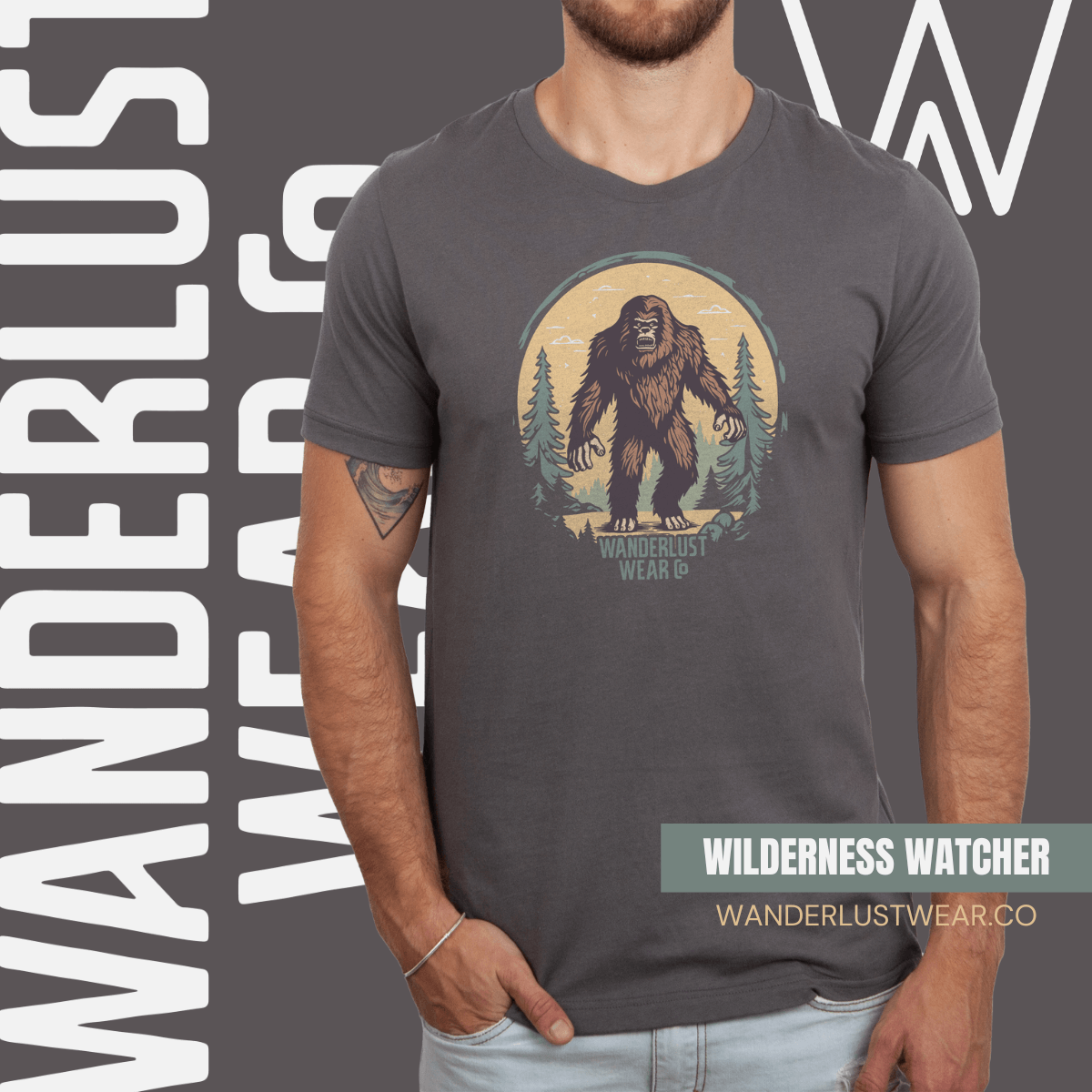 Model wearing Wilderness Watcher graphic tee in Asphalt, featuring a hand-drawn Bigfoot design with forest background and Wanderlust Wear Co. branding